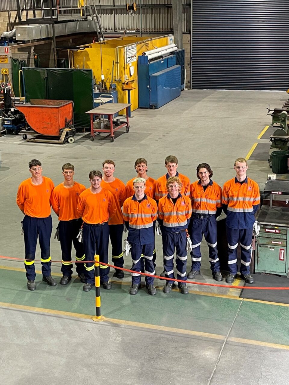 2024 tomago aluminium apprentices standing together for photo. Young men standing together in high vis.